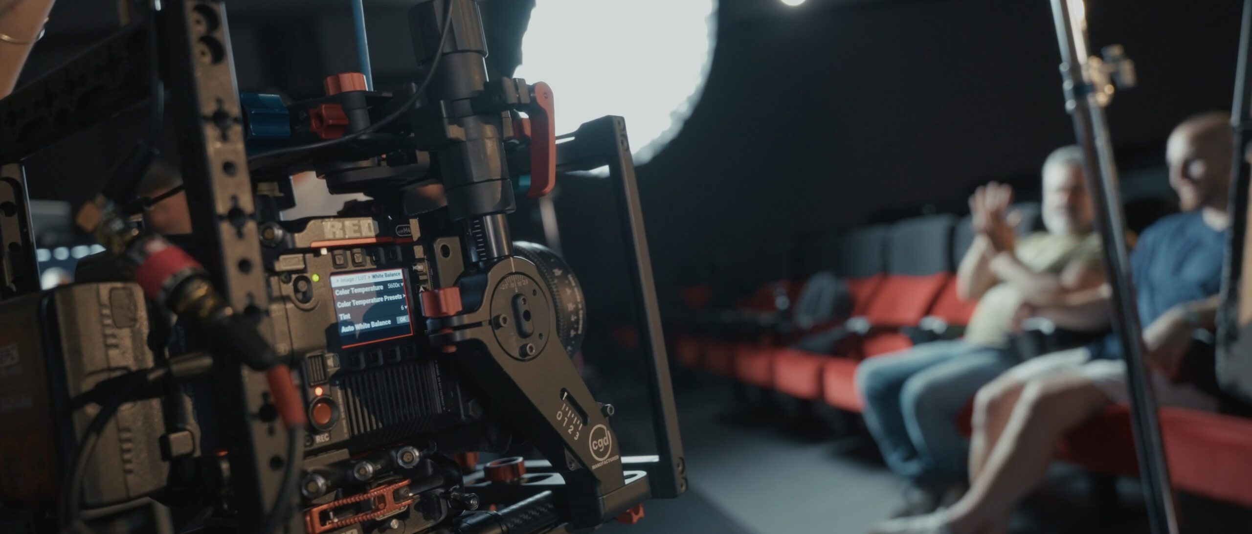 Red Foundation | Outlabs — A camera is set up in a dark room, ready to capture a scene.